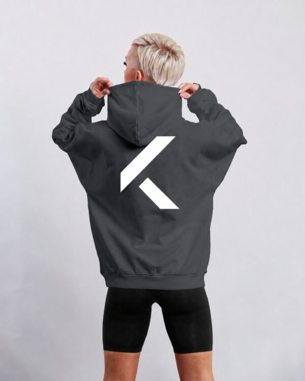 Rear view of India Ink Grey oversized hoodie featuring large white KK logo back print. Clean minimalist design with dropped shoulders and premium heavyweight construction