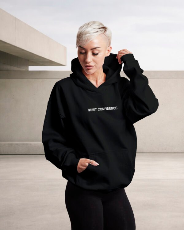 kat-krush-Quiet-confidence-black-hoodie-front-car-park Minimal streetwear black hoodie Quiet Confidence urban aesthetic UK brand