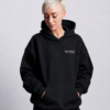 Waist-up portrait of oversized Kat Krush hoodie showing relaxed drape, dropped shoulders and structured heavyweight silhouette with hands in pockets.