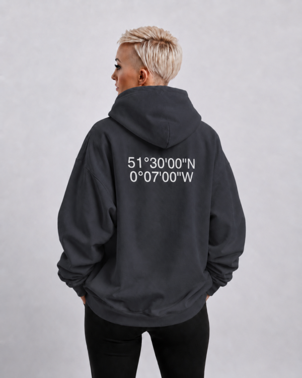 kk-hoodie-london-india-ink-grey-back-casual Waist-up fit shot of India ink grey oversized hoodie with London coordinates back print. Clean oversized silhouette with dropped shoulders and minimal streetwear styling.