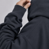 kk-hoodie-london-india- ink-grey-fabric Detailed fabric close-up of India ink grey oversized hoodie showing heavyweight organic cotton texture, shoulder seam detail, ribbed cuff, and premium construction