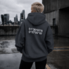 kk-hoodie-london-india-ink-grey-rooftop India ink grey oversized London coordinates hoodie styled on rooftop overlooking London skyline. Minimal streetwear aesthetic with cinematic concrete setting and relaxed oversized fit.
