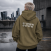 kk-hoodie-london-khaki-concrete Khaki oversized London coordinates hoodie styled on rooftop overlooking London skyline. Minimal streetwear aesthetic with cinematic concrete setting and relaxed oversized fit.