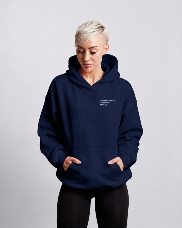 Front view of oversized french navy minimalist hoodie with subtle chest typography print, relaxed fit, kangaroo pocket, and premium heavyweight fabric styled in a clean studio setting.
