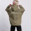 kk-hoodie-not-loud-just-powerful-back-print-khaki Back view of oversized khaki heavyweight hoodie featuring bold white “KAT KRUSH — DESIGNED IN THE UK — NOT LOUD. JUST POWERFUL” typography print, styled in a clean studio setting with relaxed minimalist streetwear aesthetic.