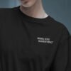 Minimal black oversized streetwear t-shirt with small chest typography print styled in futuristic editorial fashion portrait