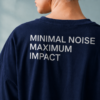 Detailed close-up of oversized French navy t-shirt back print reading “MINIMAL NOISE MAXIMUM IMPACT” showing premium fabric texture and oversized fit