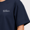 Detailed close-up of oversized French navy t-shirt featuring minimalist “NOT LOUD JUST POWERFUL” chest print, smooth heavyweight fabric texture, and wide sleeve construction.