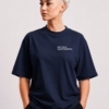 Front studio view of oversized French navy Kat Krush t-shirt featuring minimalist “NOT LOUD JUST POWERFUL” white chest print on heavyweight premium fabric with relaxed fit silhouette.