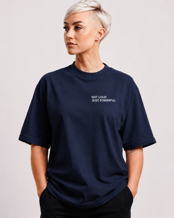 Front studio view of oversized French navy Kat Krush t-shirt featuring minimalist “NOT LOUD JUST POWERFUL” white chest print on heavyweight premium fabric with relaxed fit silhouette.