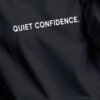 quiet-confidence-hoodie-black-print-detail Quiet Confidence hoodie print detail white typography black oversized hoodie