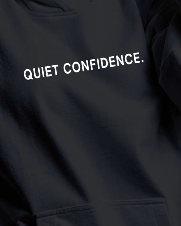 quiet-confidence-hoodie-black-print-detail Quiet Confidence hoodie print detail white typography black oversized hoodie