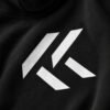 Close-up studio portrait of a black Kat Krush oversized hoodie featuring the white KK chest logo, premium heavyweight fabric, and clean minimalist aesthetic.