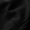 Close-up of black heavyweight hoodie fabric showing detailed knit texture, stitching, and premium construction for everyday streetwear comfort.