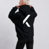 Black oversized Kat Krush hoodie shown from the back with oversized white KK logo graphic. Minimal streetwear style with relaxed silhouette