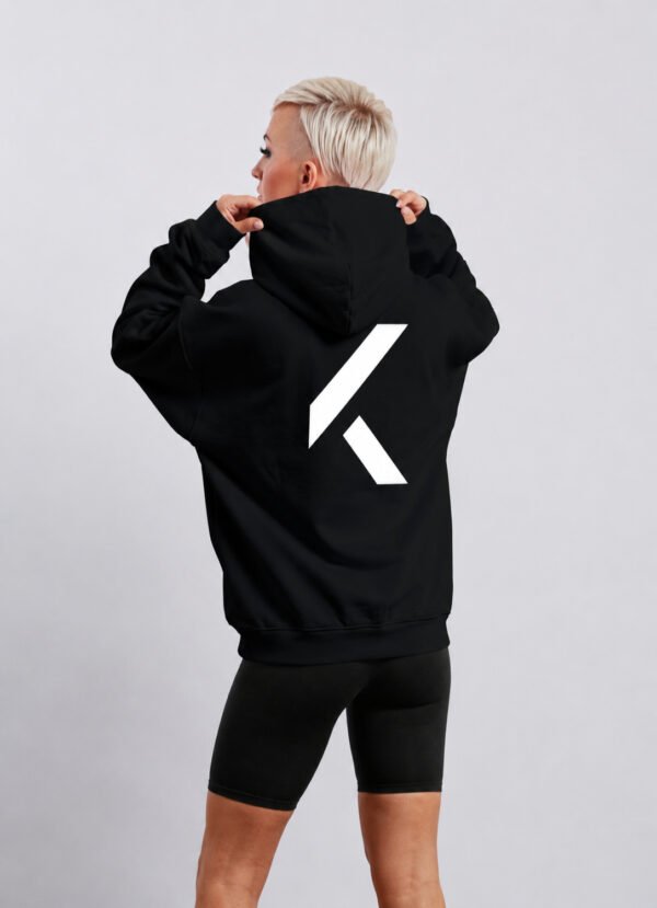 Black oversized Kat Krush hoodie shown from the back with oversized white KK logo graphic. Minimal streetwear style with relaxed silhouette