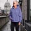 Female model wearing a violet oversized Kat Krush hoodie in a London streetwear scene near St Paul’s Cathedral.