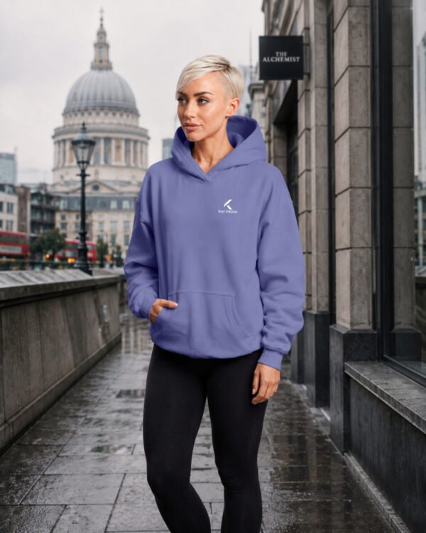 Female model wearing a violet oversized Kat Krush hoodie in a London streetwear scene near St Paul’s Cathedral.