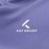 Close-up of the white Kat Krush chest logo printed on violet hoodie fabric