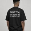 kk-tee-bristol-black-back-waist-up-coordinates Waist-up rear view of a black oversized Bristol coordinates T-shirt displaying the city name and coordinate print on the back.