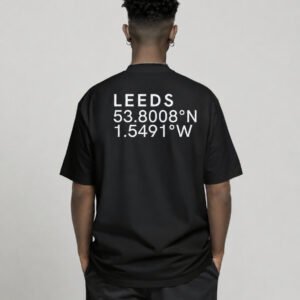 Black oversized Leeds coordinates T-shirt featuring Leeds city coordinates printed on the back, worn by a model in a relaxed studio setting.