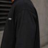 Detailed view of the shoulder and sleeve fabric on a black Leeds coordinates T-shirt, showcasing heavyweight cotton construction.