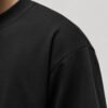 Close-up of heavyweight cotton fabric and shoulder seam detail on a black Liverpool coordinates T-shirt.