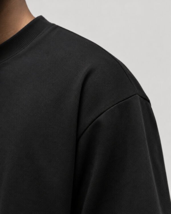Close-up of heavyweight cotton fabric and shoulder seam detail on a black Liverpool coordinates T-shirt.
