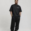 Angled view of black oversized London Signature coordinates T-shirt showing minimalist London coordinates chest print, premium heavyweight fabric and oversized fit.