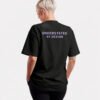 Rear view of a black Kat Krush oversized T-shirt featuring the Understated By Design statement print across the upper back in a minimalist studio setting.