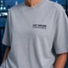 "Heather Grey oversized Kat Krush London coordinates t-shirt with black chest logo in an urban evening setting. Premium heavyweight cotton and relaxed oversized fit."