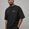 Male model wearing a black Leeds Signature oversized heavyweight T-shirt with a subtle white Leeds coordinates chest design.