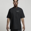 Male model wearing a black Liverpool Signature oversized heavyweight T-shirt featuring a minimalist white left chest coordinates print.