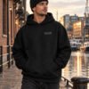 Male model wearing black Kat Krush fisherman beanie and black Bristol Signature heavyweight hoodie at Bristol harbourside
