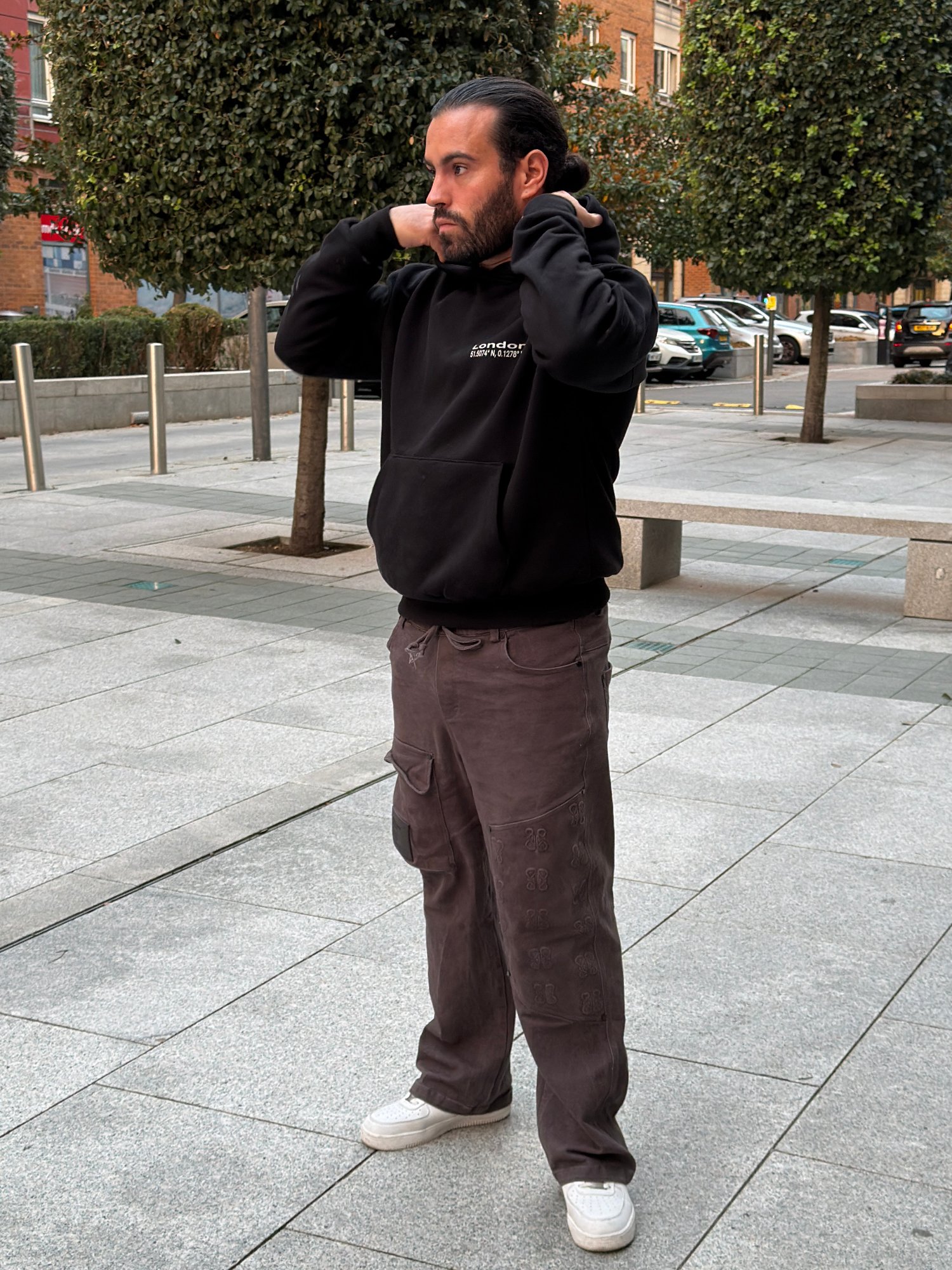 Home 4 André wearing a black Kat Krush London Signature hoodie with brown cargo trousers and white trainers