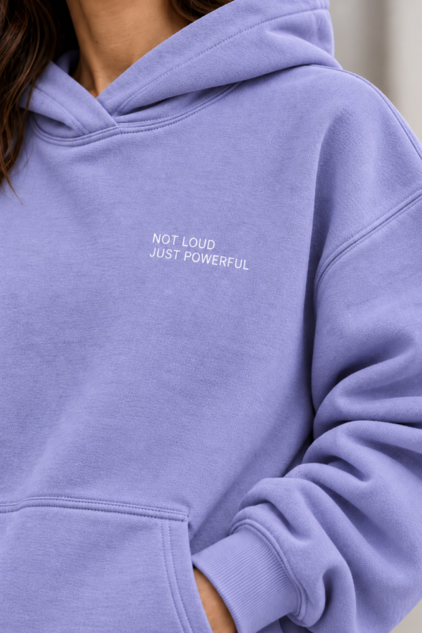 kk Lavender Hoodie, Quietly Powerful Detailed close-up of Kat Krush Not Loud Just Powerful oversized hoodie in violet, highlighting fabric texture, white chest print and ribbed cuff.